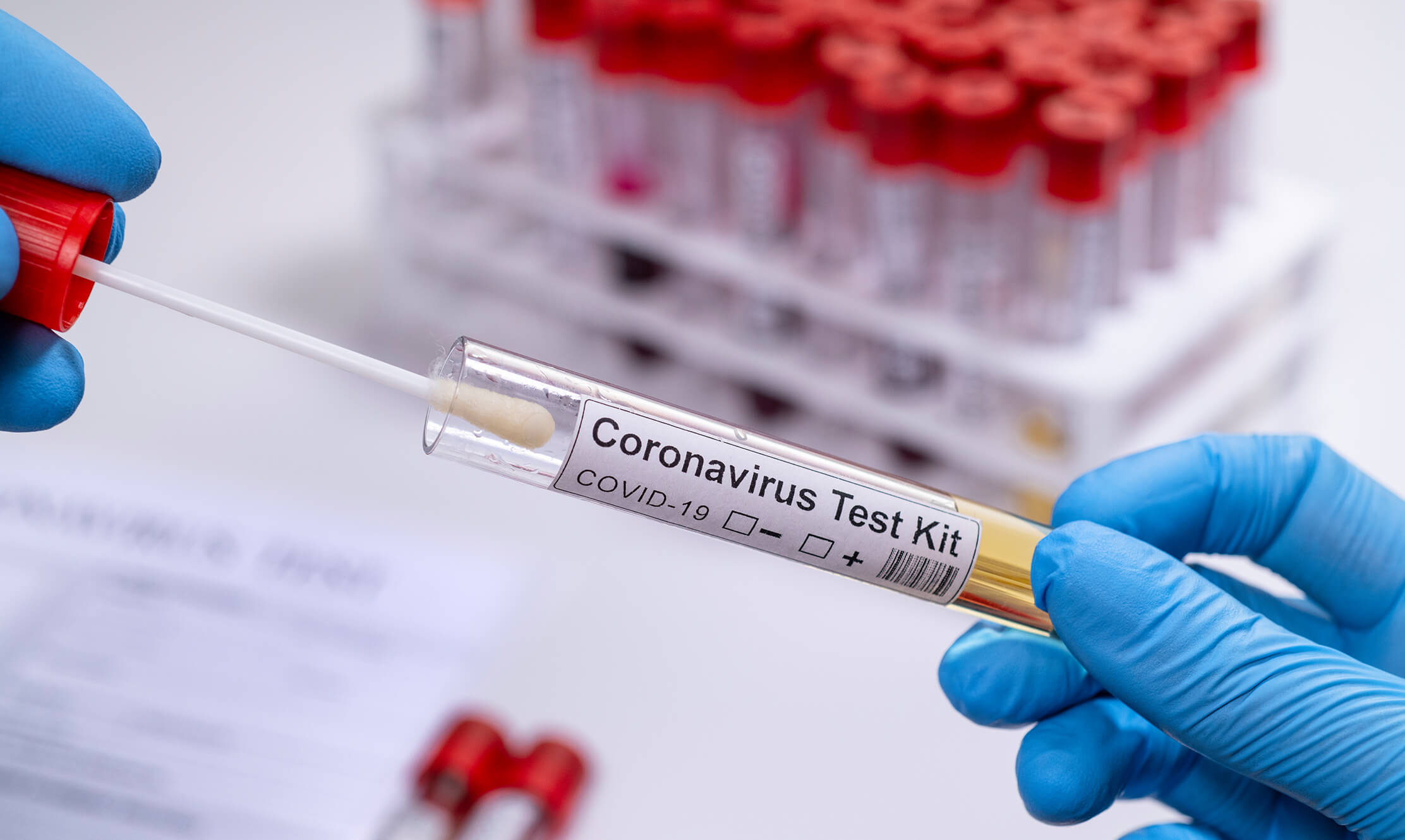 A technician administering a COVID-19 test with syringes create with medical injection molding.