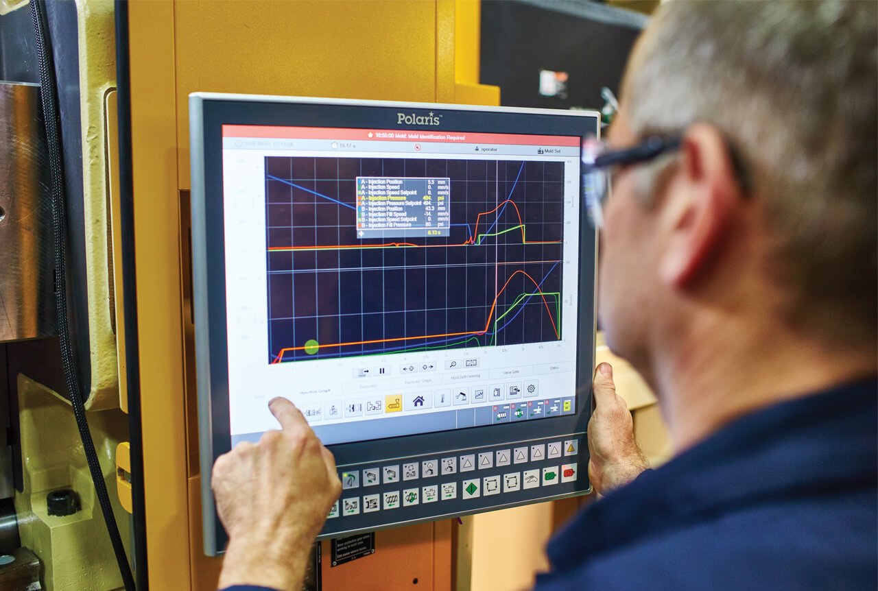  Un técnico de Husky actualizando un sistema de inyección de molde